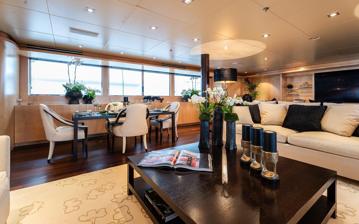 a large room with a table and chairs aboard MONEIKOS Yacht for Sale