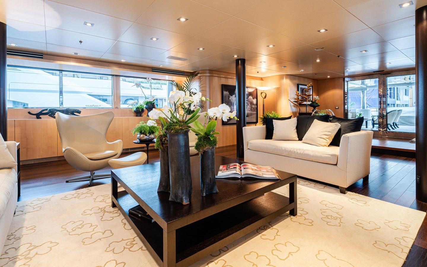 a living room with a large window aboard MONEIKOS Yacht for Sale