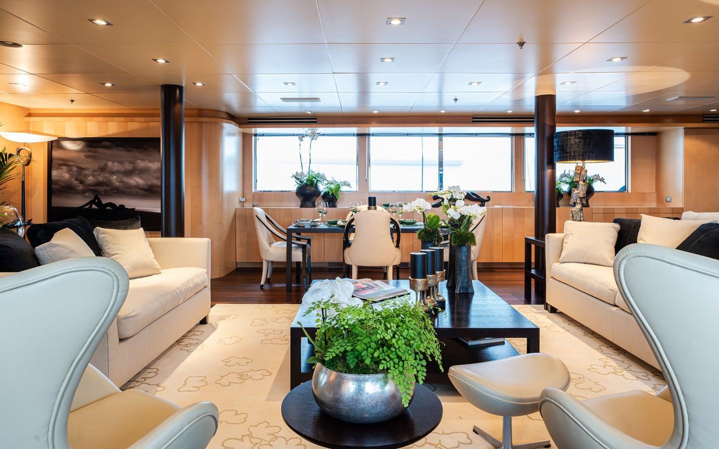 a living room with a table and chairs aboard MONEIKOS Yacht for Sale