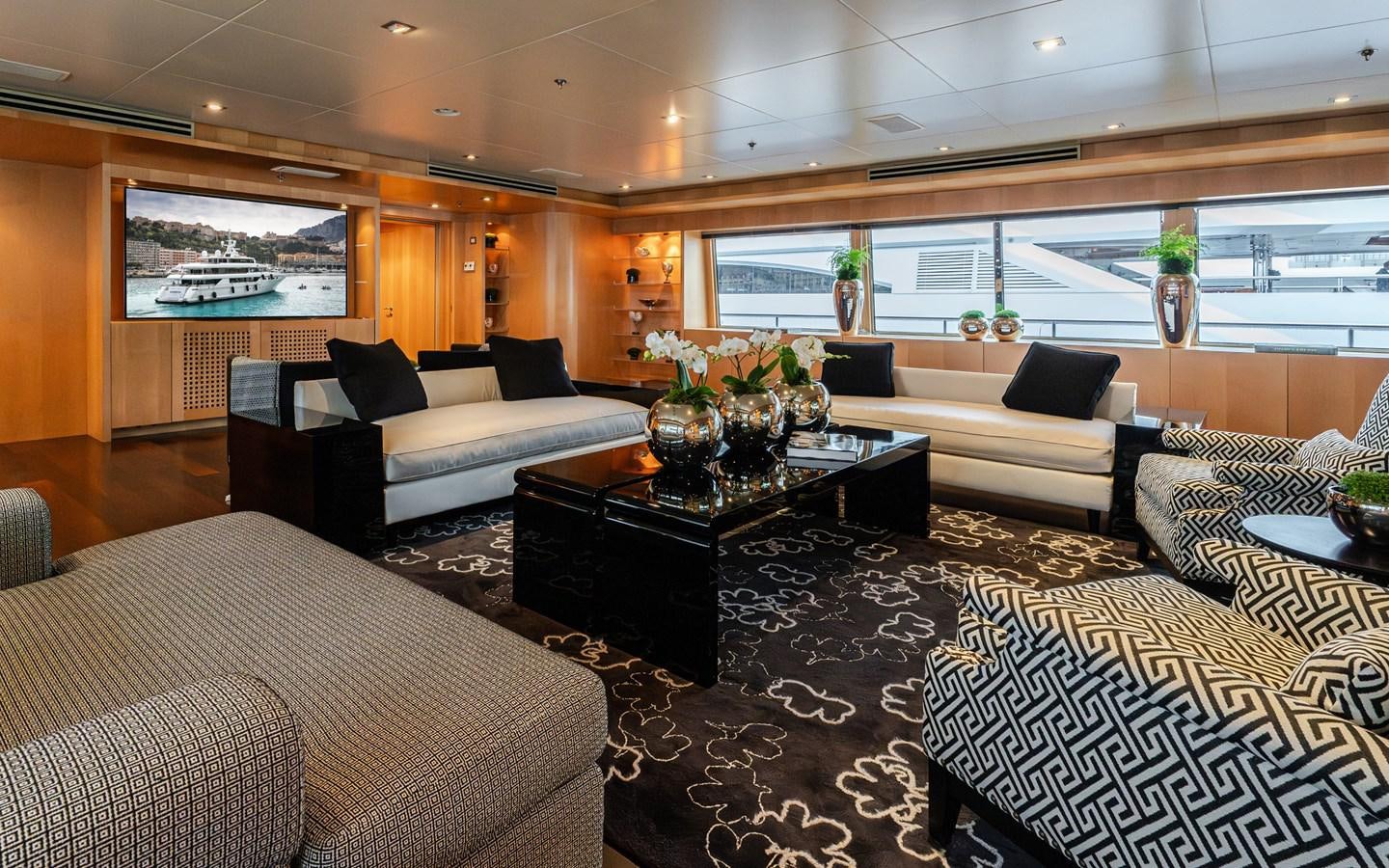 a living room with a large window aboard MONEIKOS Yacht for Sale