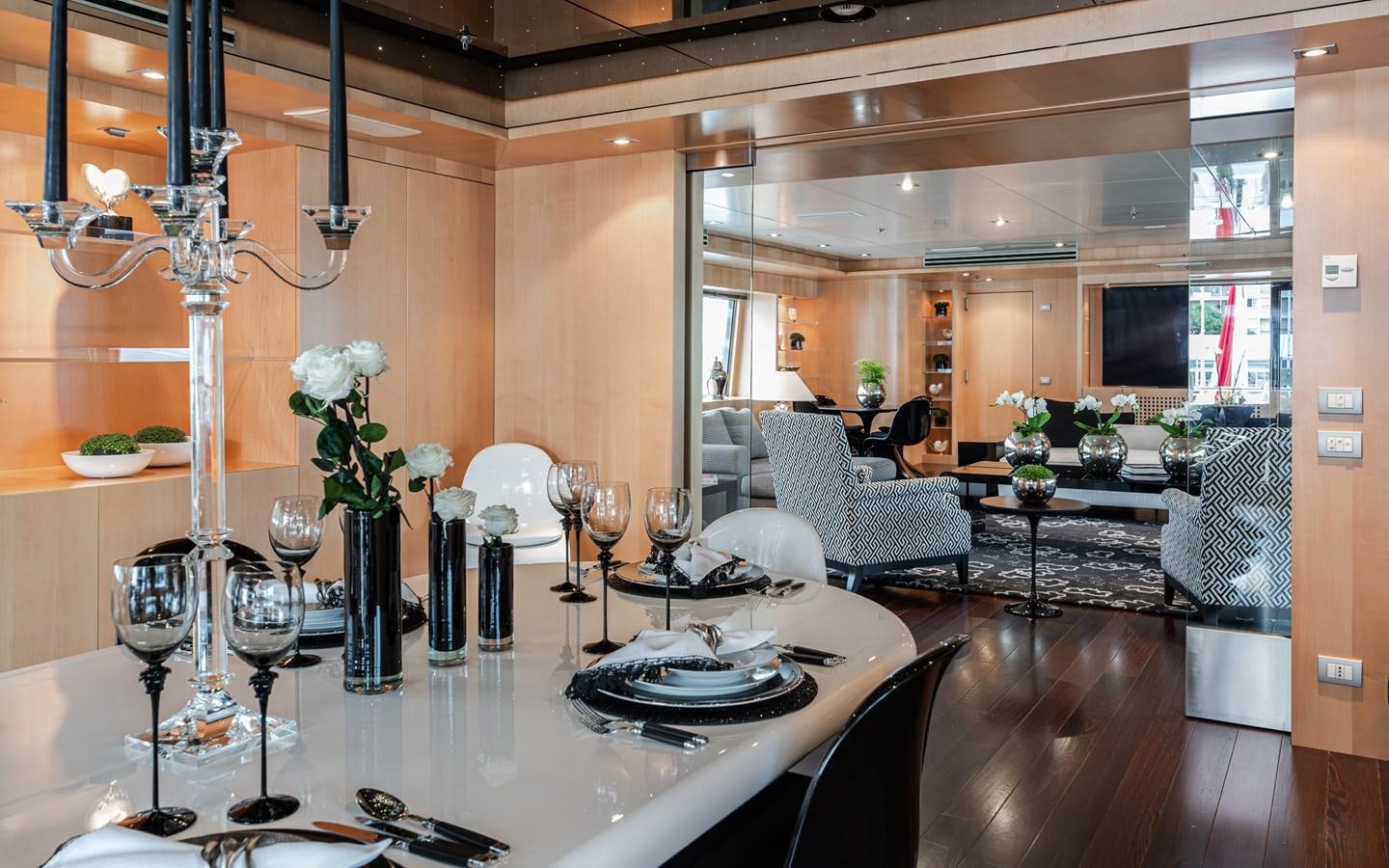 a large dining room with a chandelier aboard MONEIKOS Yacht for Sale