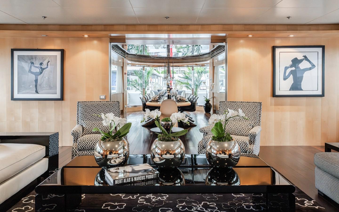 a living room with a table and chairs aboard MONEIKOS Yacht for Sale