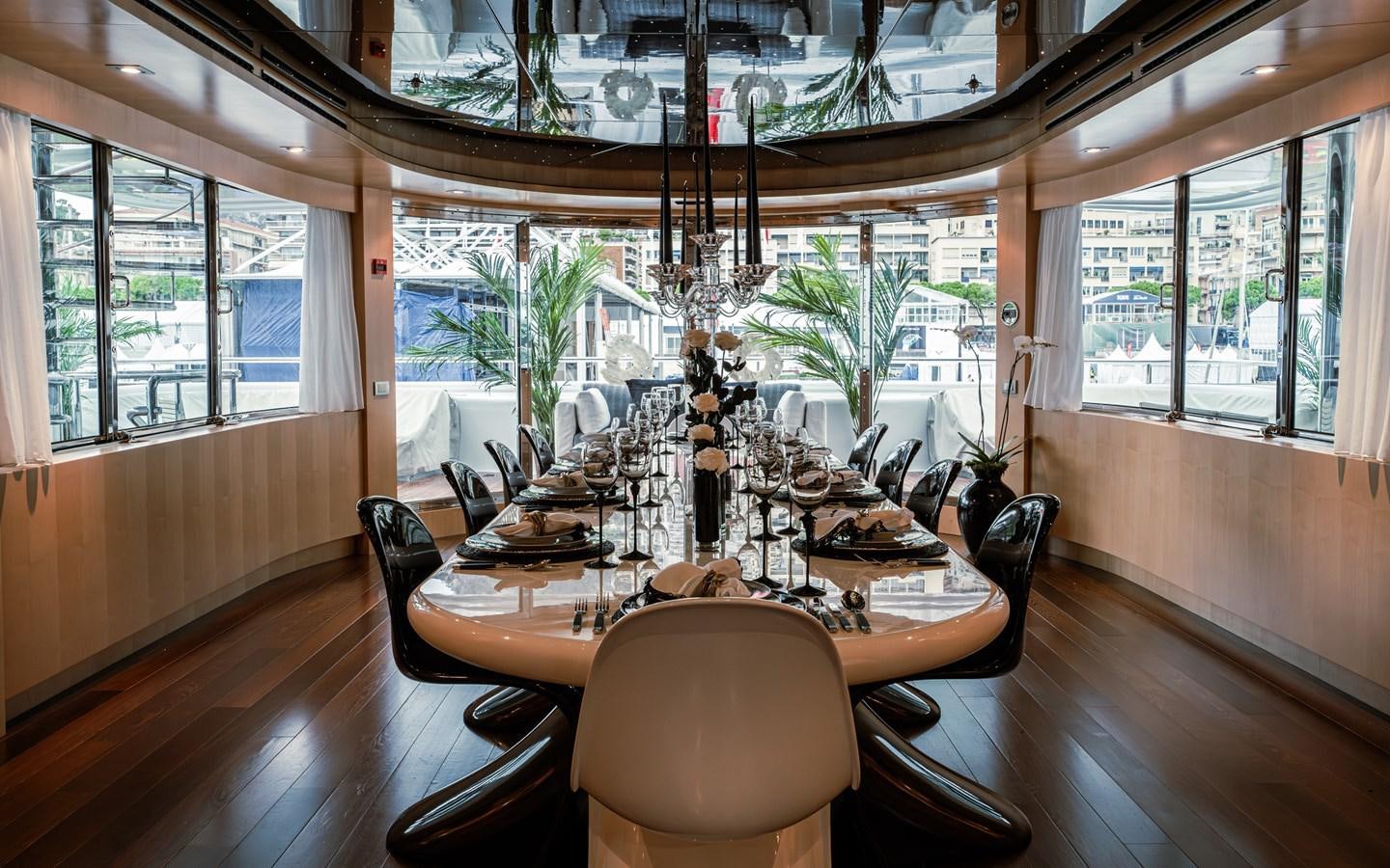 a dining room table with chairs aboard MONEIKOS Yacht for Sale