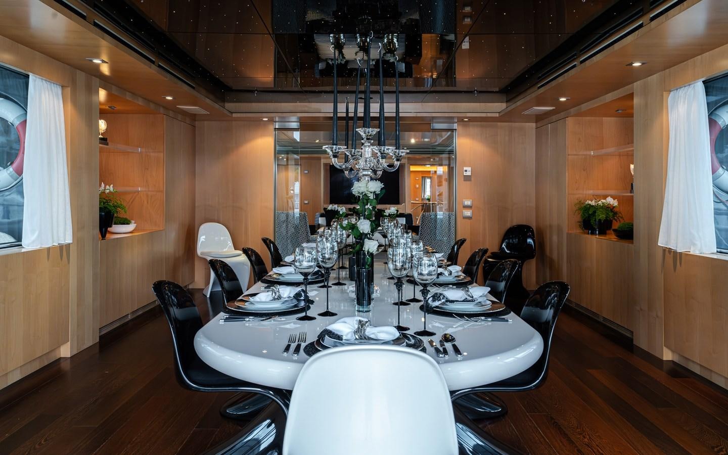 a dining room with a chandelier aboard MONEIKOS Yacht for Sale