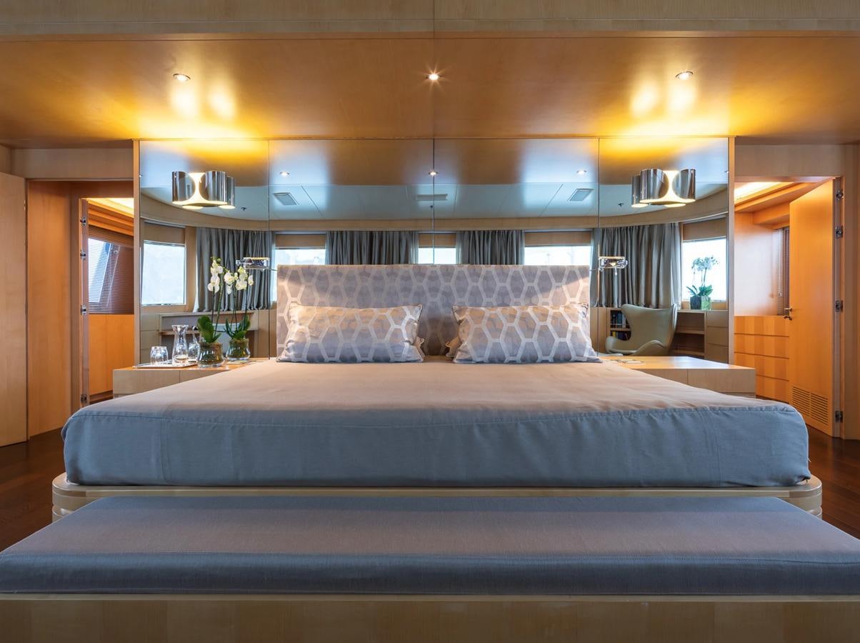 a bed with a blue sheet aboard MONEIKOS Yacht for Sale