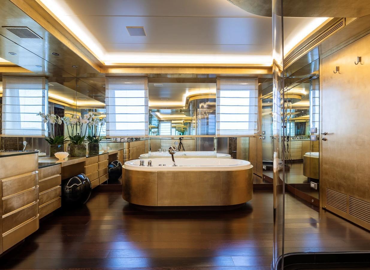 a bathroom with a tub and sinks aboard MONEIKOS Yacht for Sale