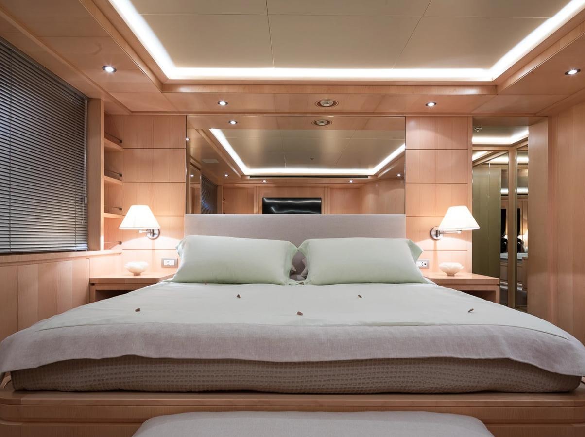 a bed with a white comforter aboard MONEIKOS Yacht for Sale
