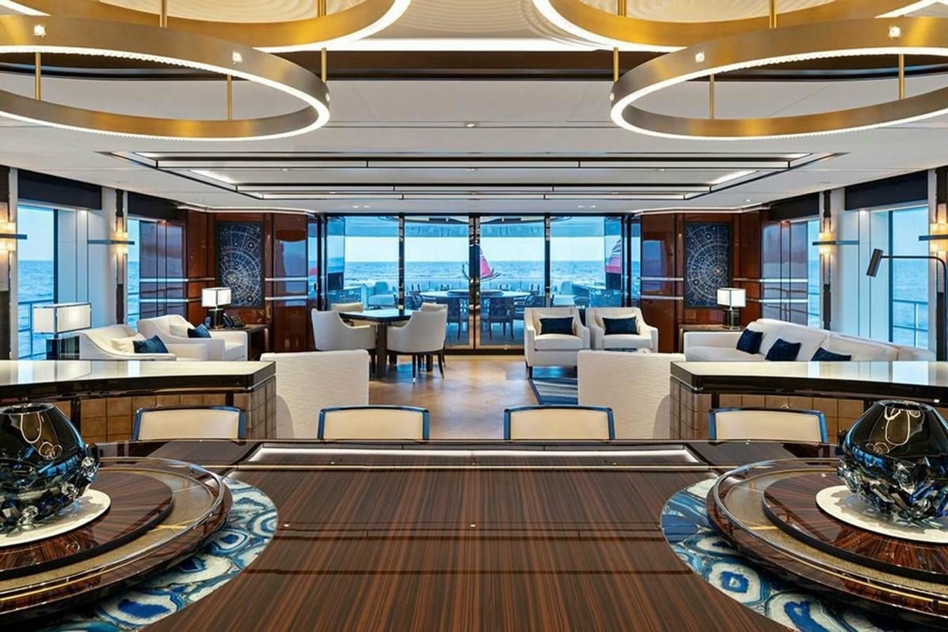 a room with a wood floor and a large window with a view of the ocean aboard LUSINE Yacht for Sale