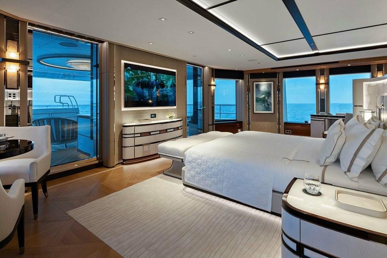 a room with a large bed and a flat screen television aboard LUSINE Yacht for Sale