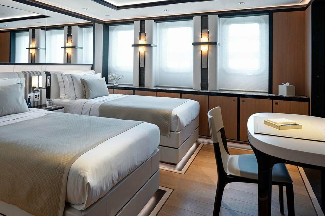 a room with two beds and a desk aboard LUSINE Yacht for Sale