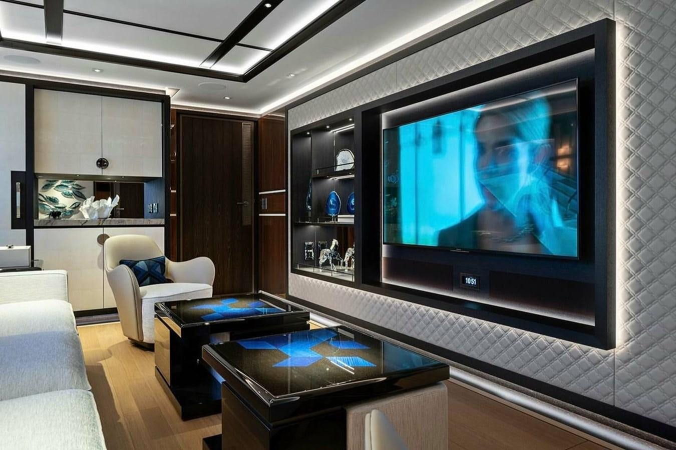a living room with a large screen aboard LUSINE Yacht for Sale
