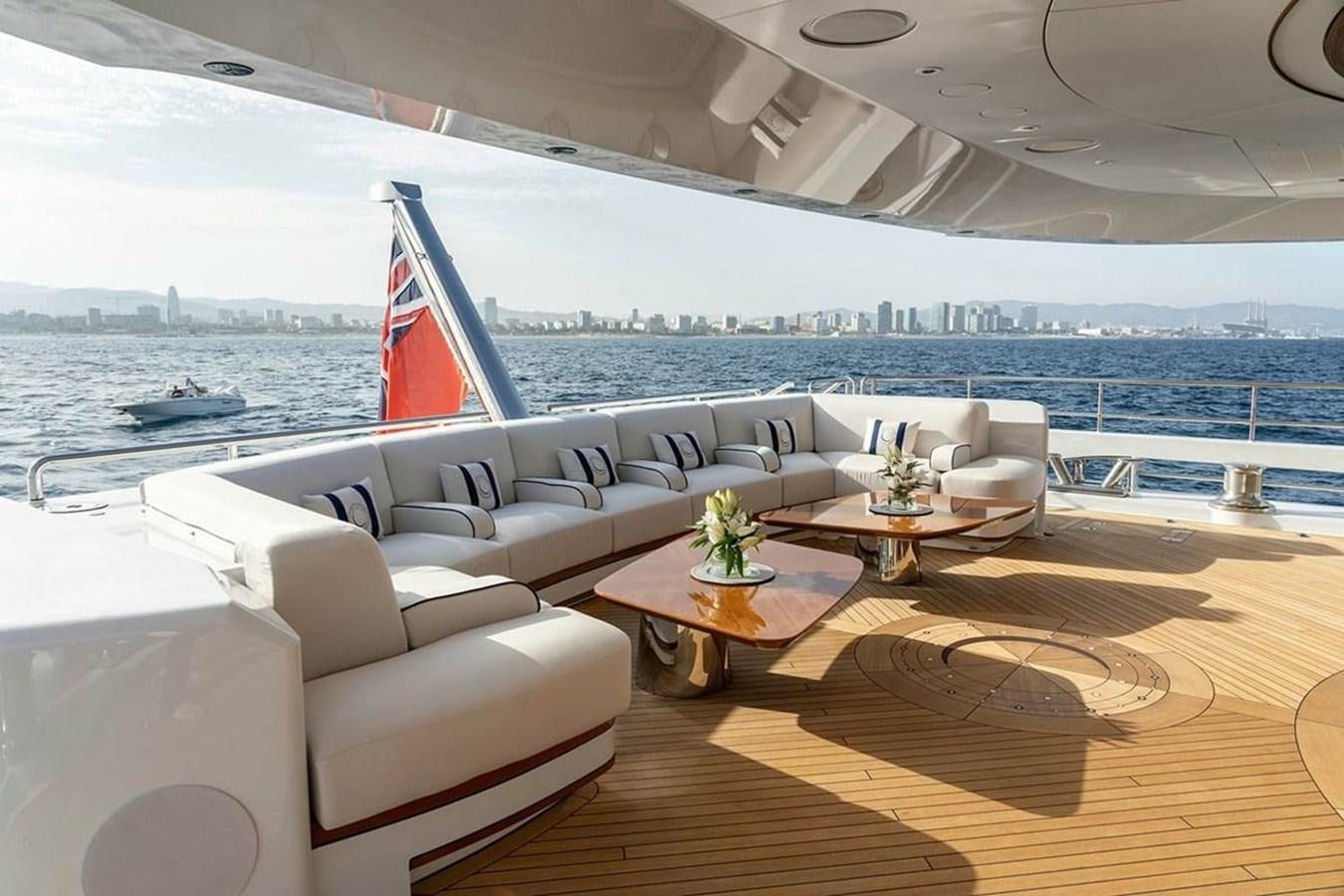 a room with a couch and a table and a flag aboard LUSINE Yacht for Sale