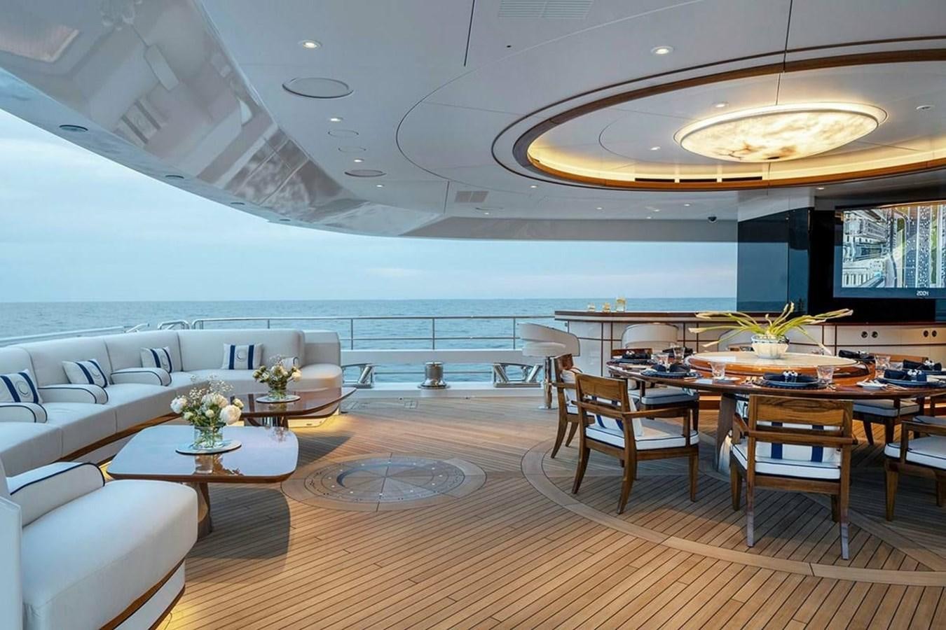 a large room with tables and chairs aboard LUSINE Yacht for Sale