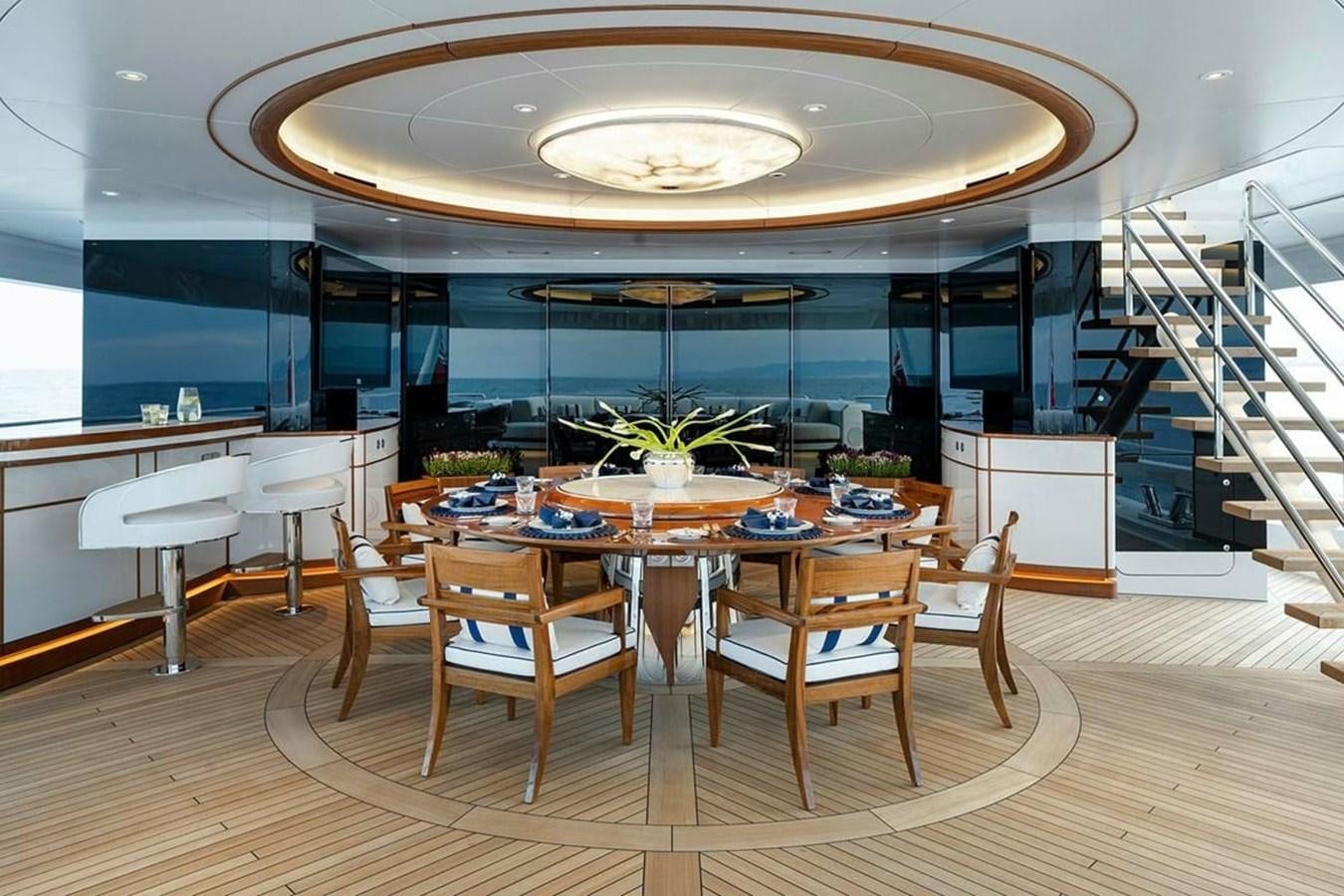 a large room with tables and chairs aboard LUSINE Yacht for Sale