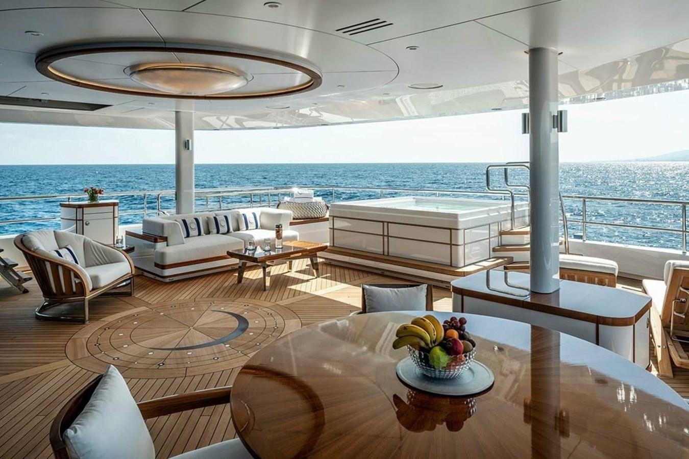a room with a table chairs and a couch aboard LUSINE Yacht for Sale