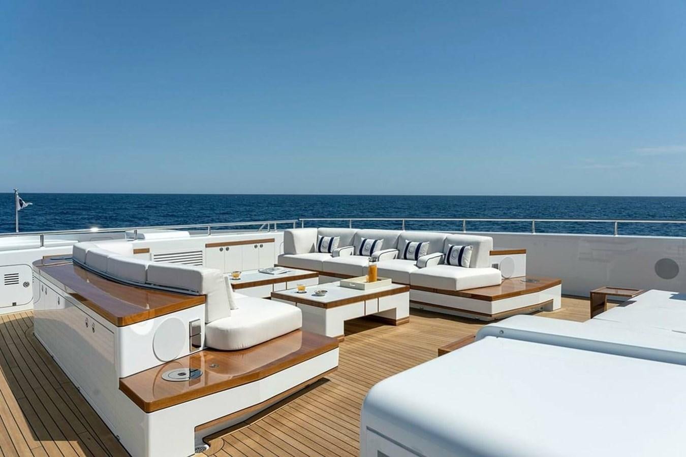 a room with a view of the ocean and a large boat aboard LUSINE Yacht for Sale
