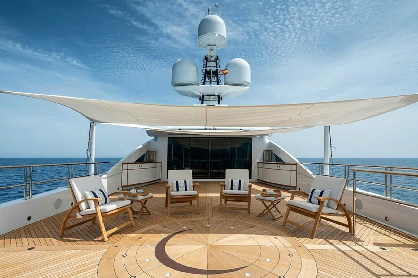 a large white boat with chairs and tables on a deck aboard LUSINE Yacht for Sale