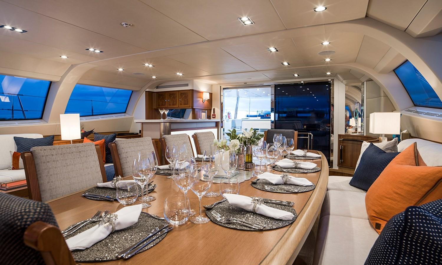 a table with plates and napkins aboard TWILIGHT Yacht for Sale