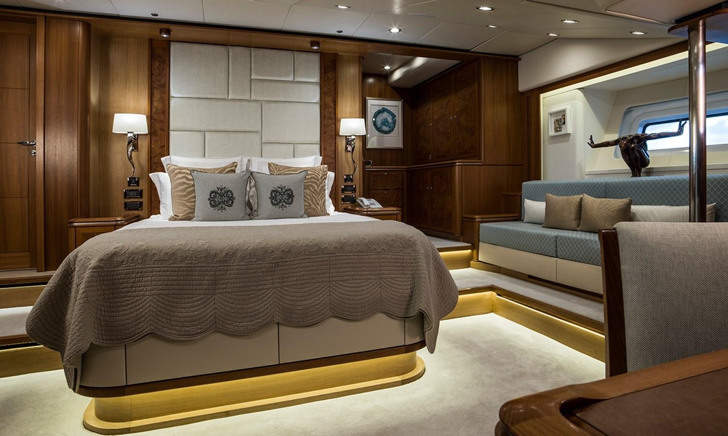 a bedroom with a bed and a couch aboard TWILIGHT Yacht for Sale