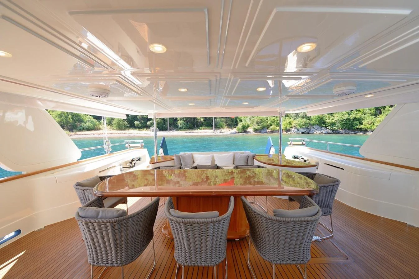 a table and chairs on a deck aboard HAG Yacht for Sale