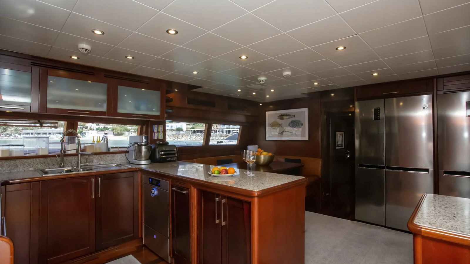 a kitchen with a stainless steel refrigerator aboard HAG Yacht for Sale