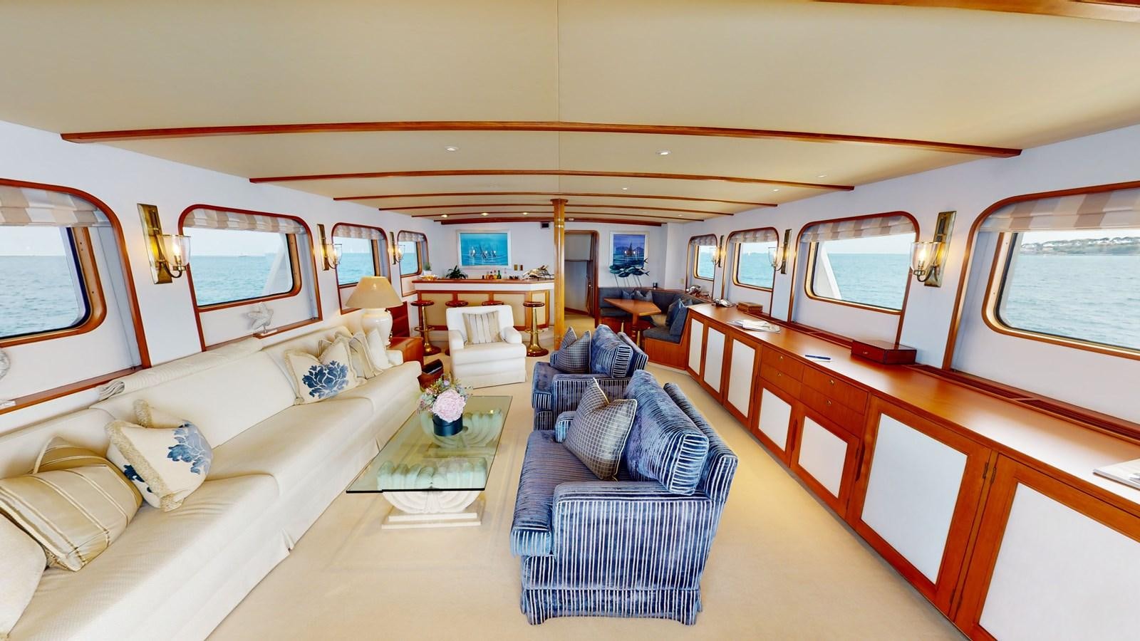 a train with a couch and a chair aboard WILAMINA Yacht for Sale