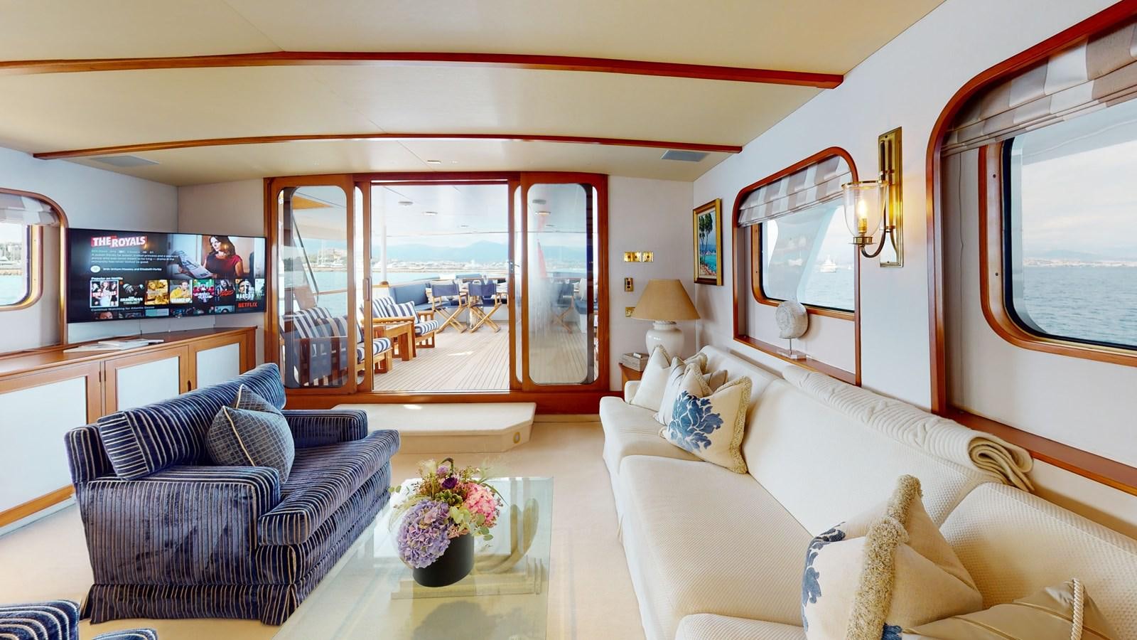 a living room with a large window aboard WILAMINA Yacht for Sale