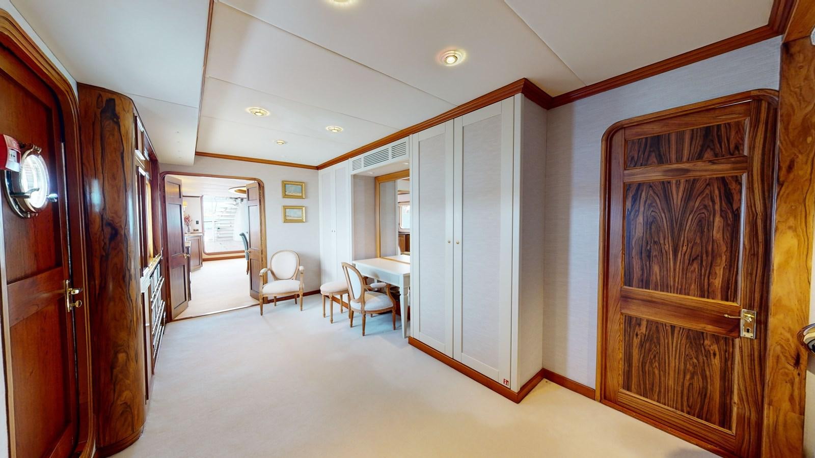 a hallway with chairs and tables aboard WILAMINA Yacht for Sale