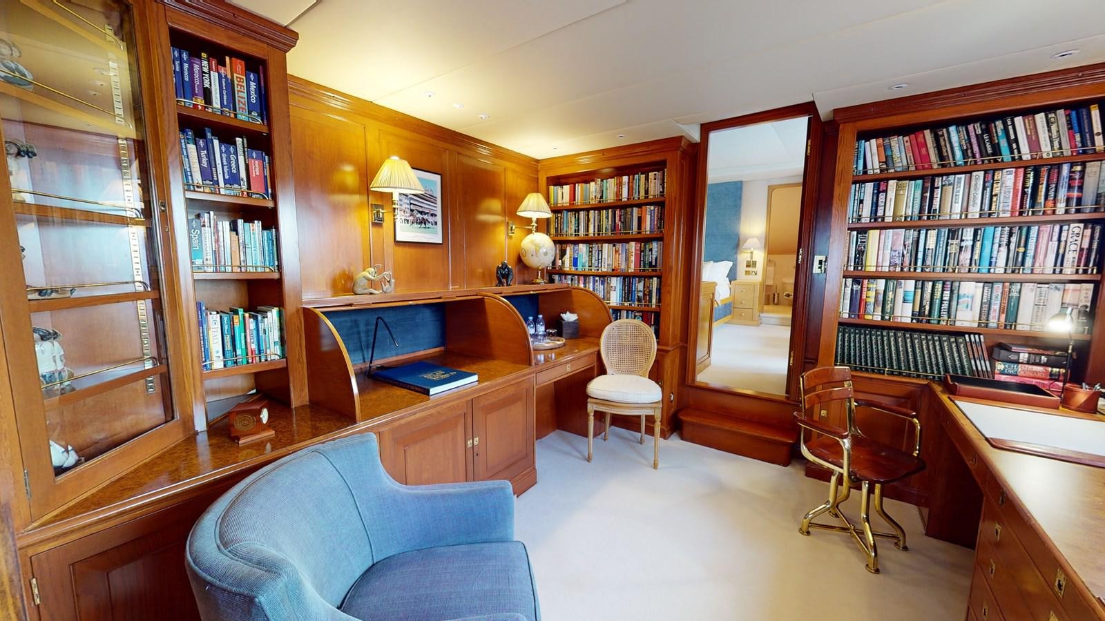 a room with a desk and chairs aboard WILAMINA Yacht for Sale