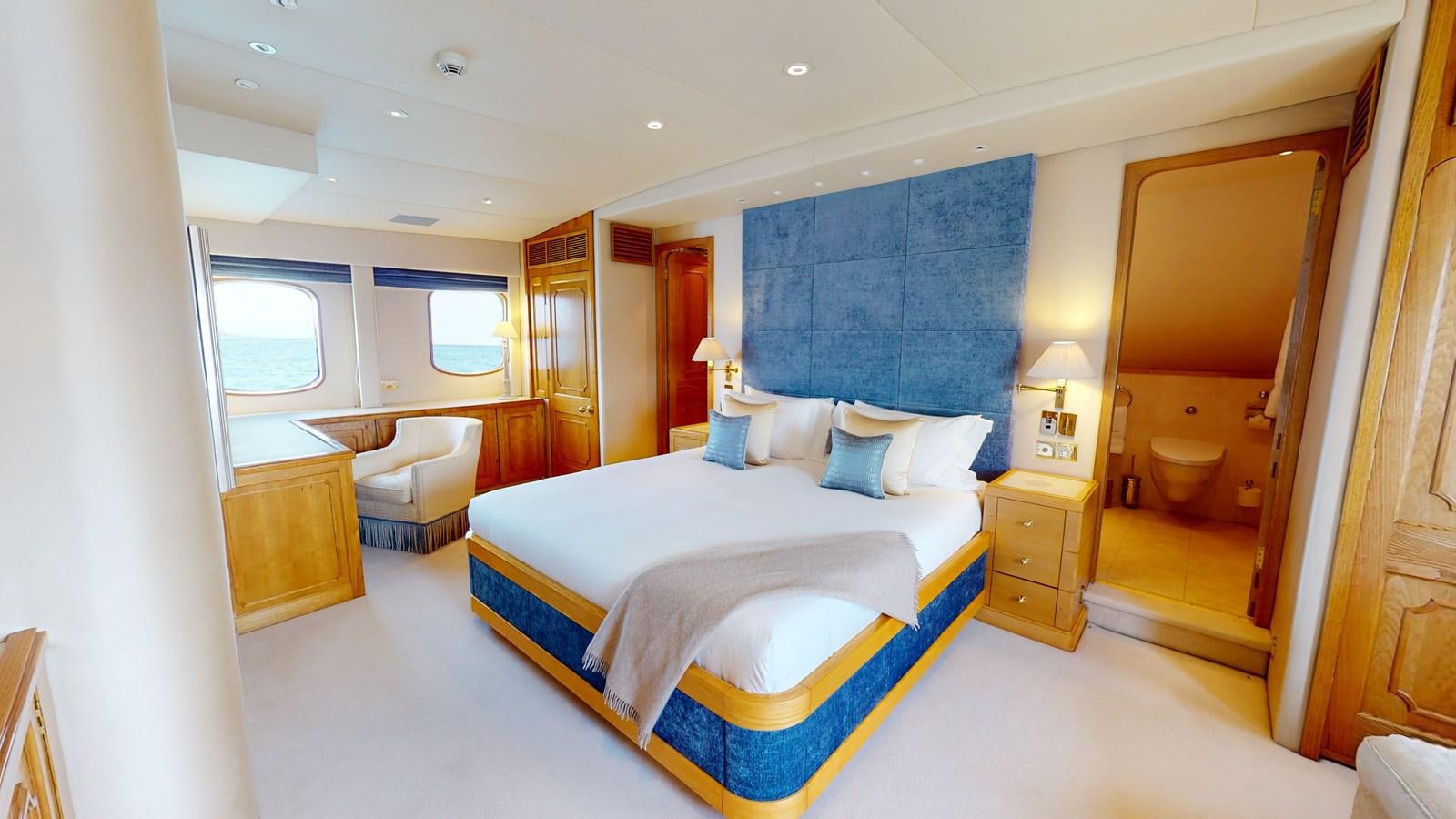 a room with a bed and a chair aboard WILAMINA Yacht for Sale