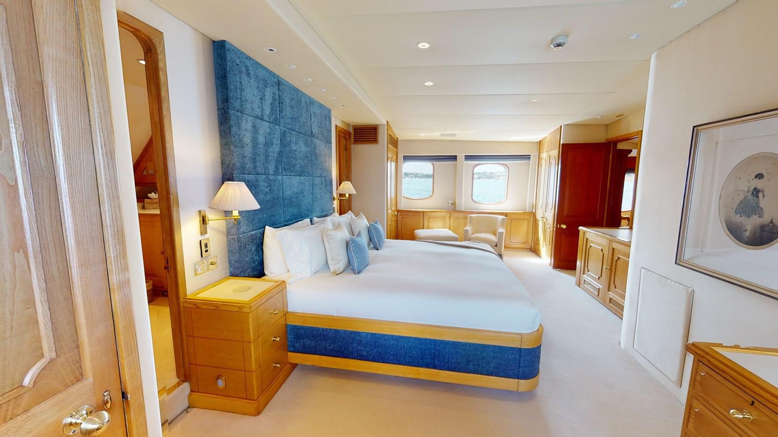 a bedroom with a bed and a desk aboard WILAMINA Yacht for Sale