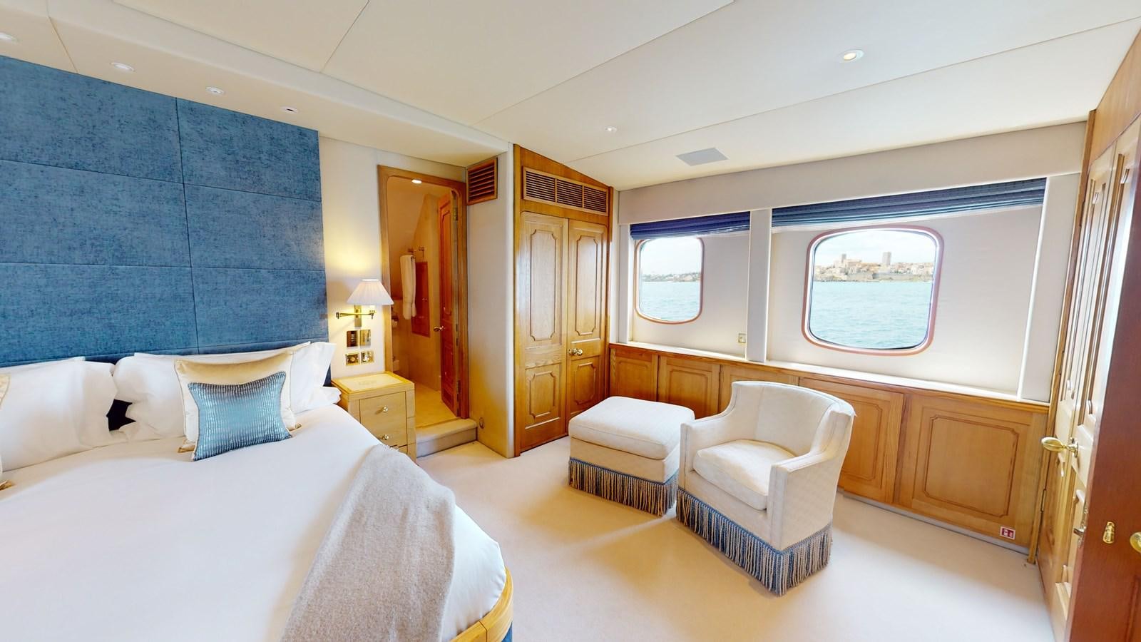 a room with a bed and a chair aboard WILAMINA Yacht for Sale
