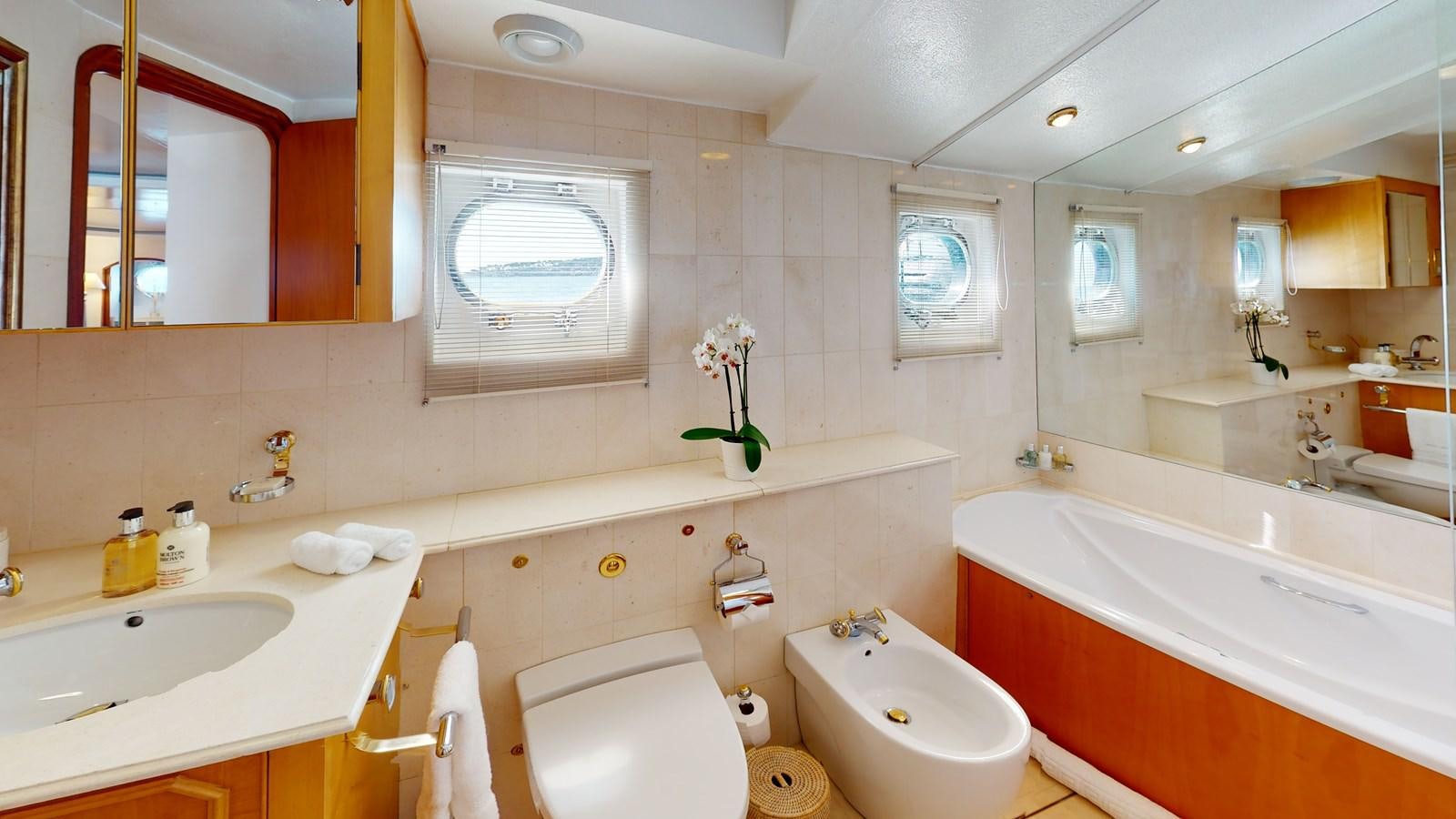 a bathroom with a tub sink and toilet aboard WILAMINA Yacht for Sale