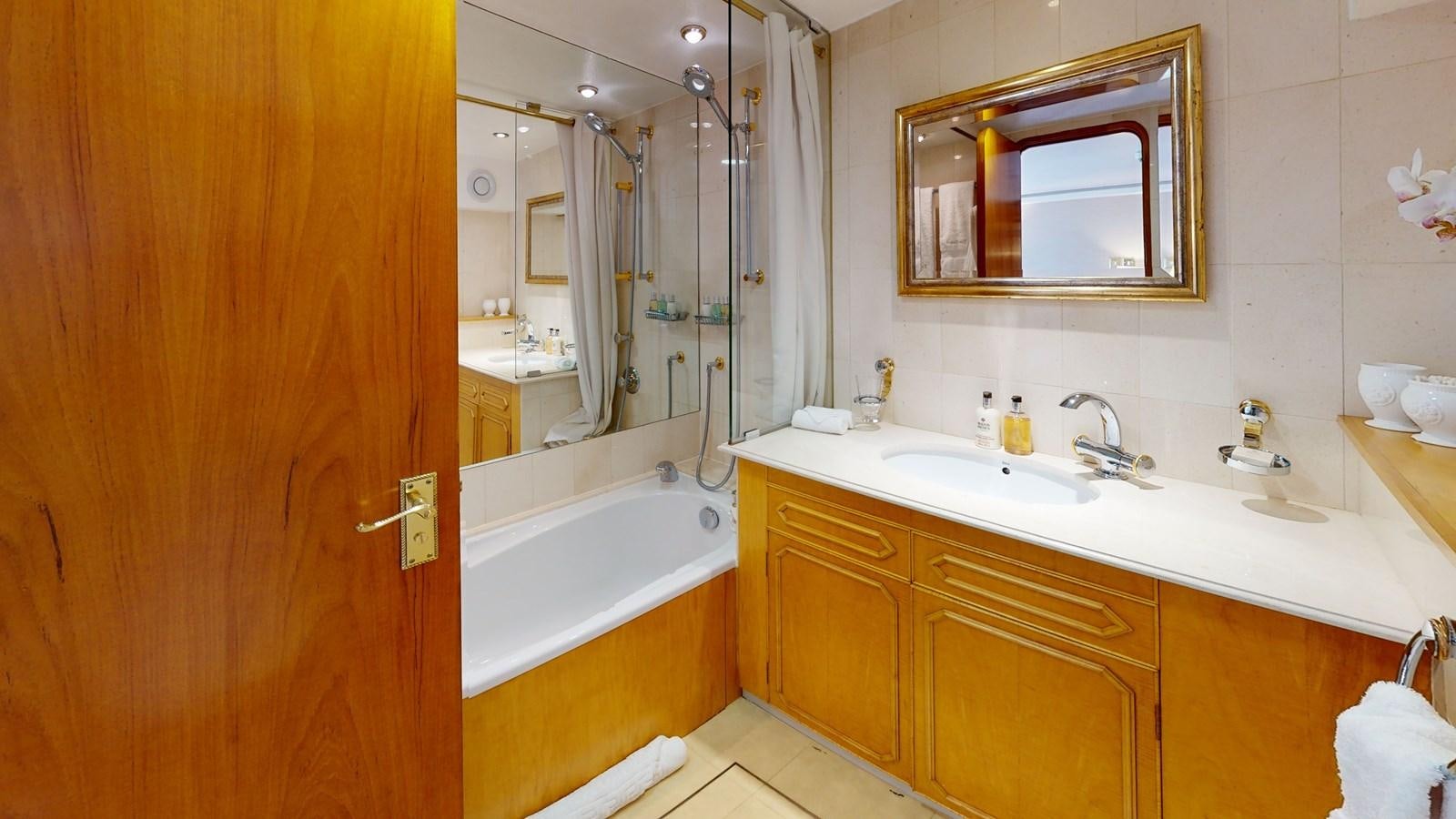 a bathroom with a large mirror aboard WILAMINA Yacht for Sale