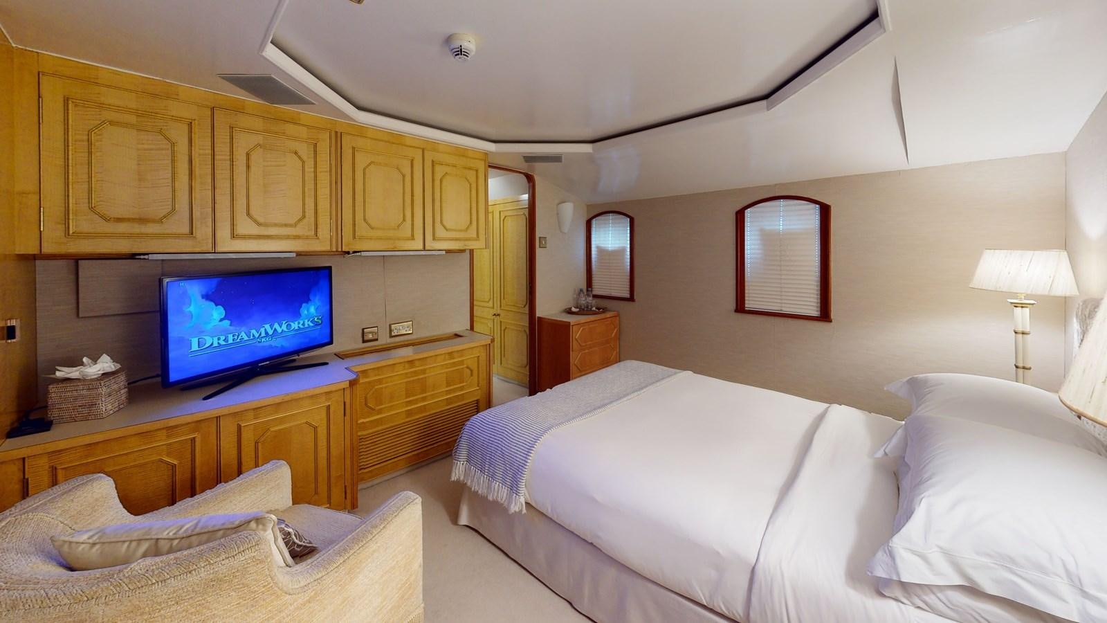 a bedroom with a tv and a bed aboard WILAMINA Yacht for Sale