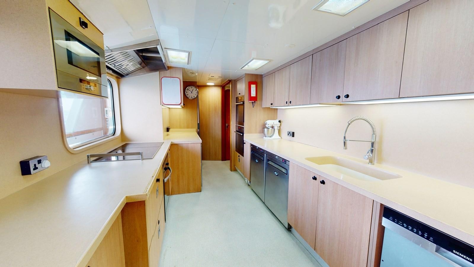 a kitchen with a sink and cabinets aboard WILAMINA Yacht for Sale