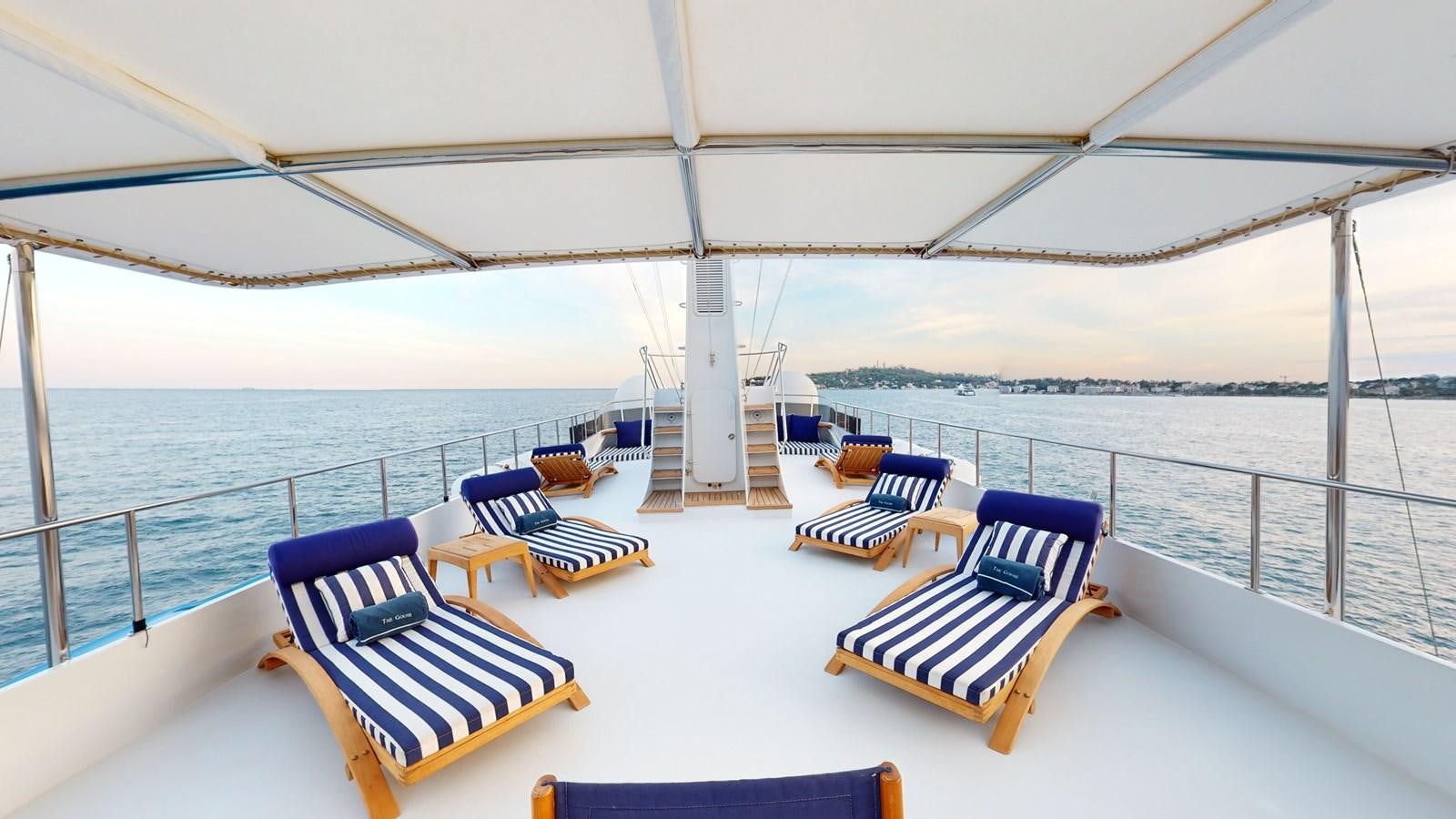 a boat with lounge chairs on the deck aboard WILAMINA Yacht for Sale