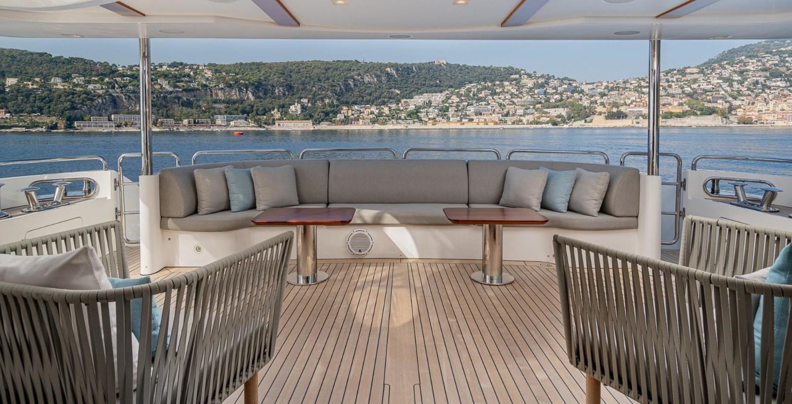 a deck with chairs and tables on it aboard EDESIA Yacht for Charter