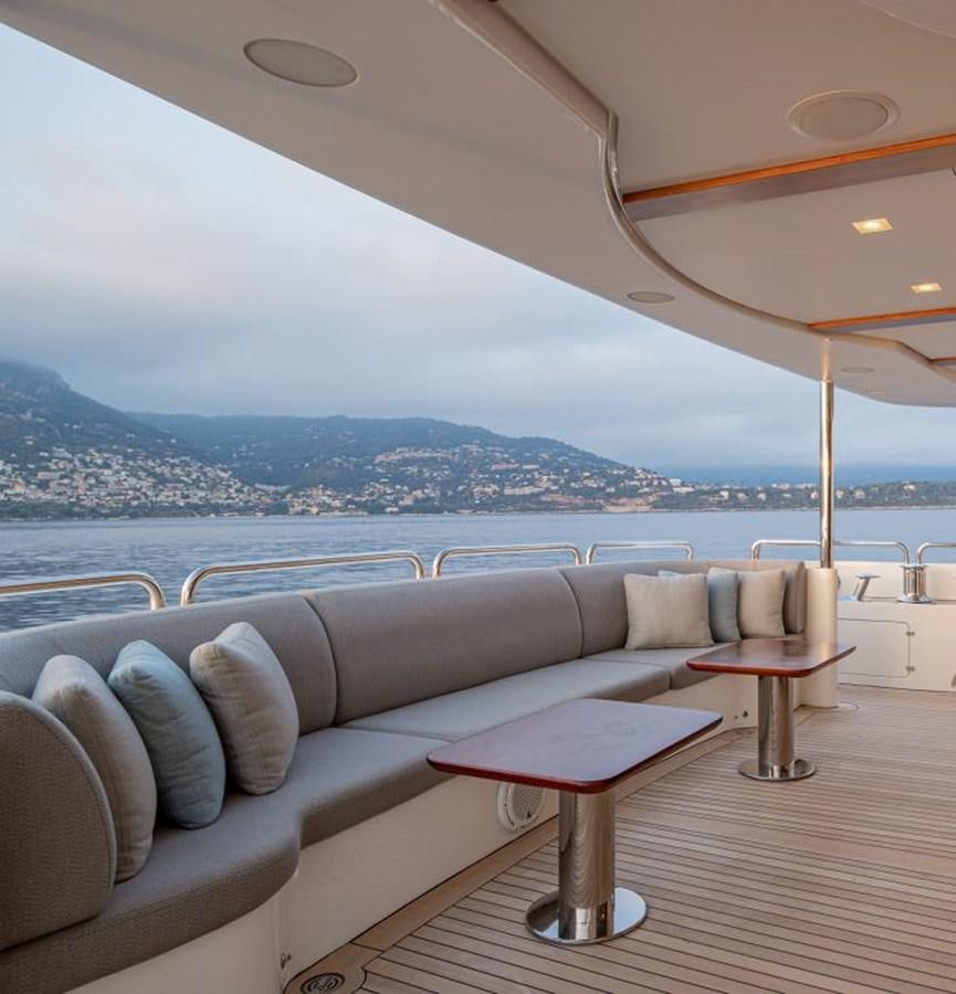 a lounge area with a view of a city and water aboard EDESIA Yacht for Charter