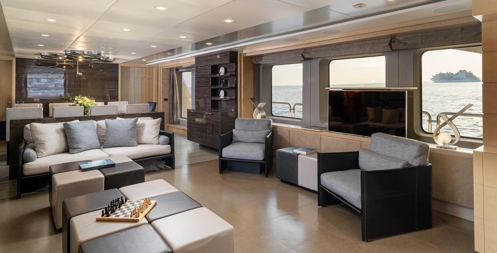a living room with a couch and a fireplace aboard EDESIA Yacht for Charter