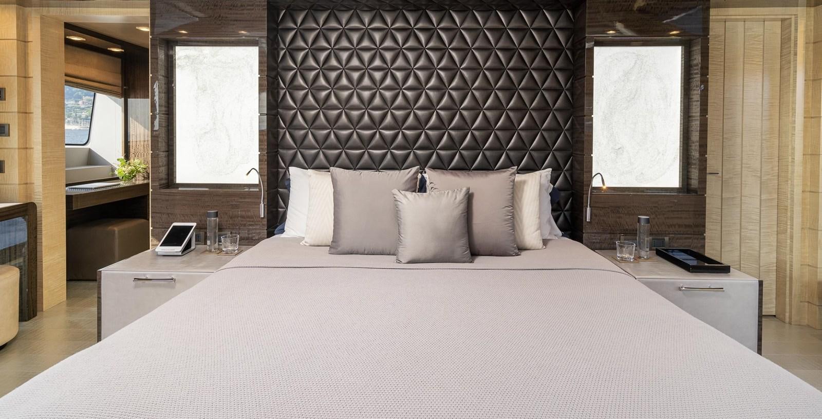 a bed with white sheets aboard EDESIA Yacht for Charter