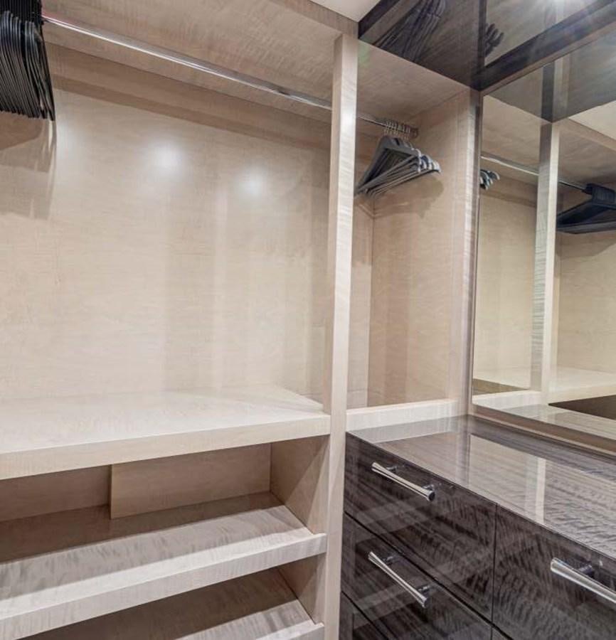 a room with a glass door and a shelf with a mirror aboard EDESIA Yacht for Charter