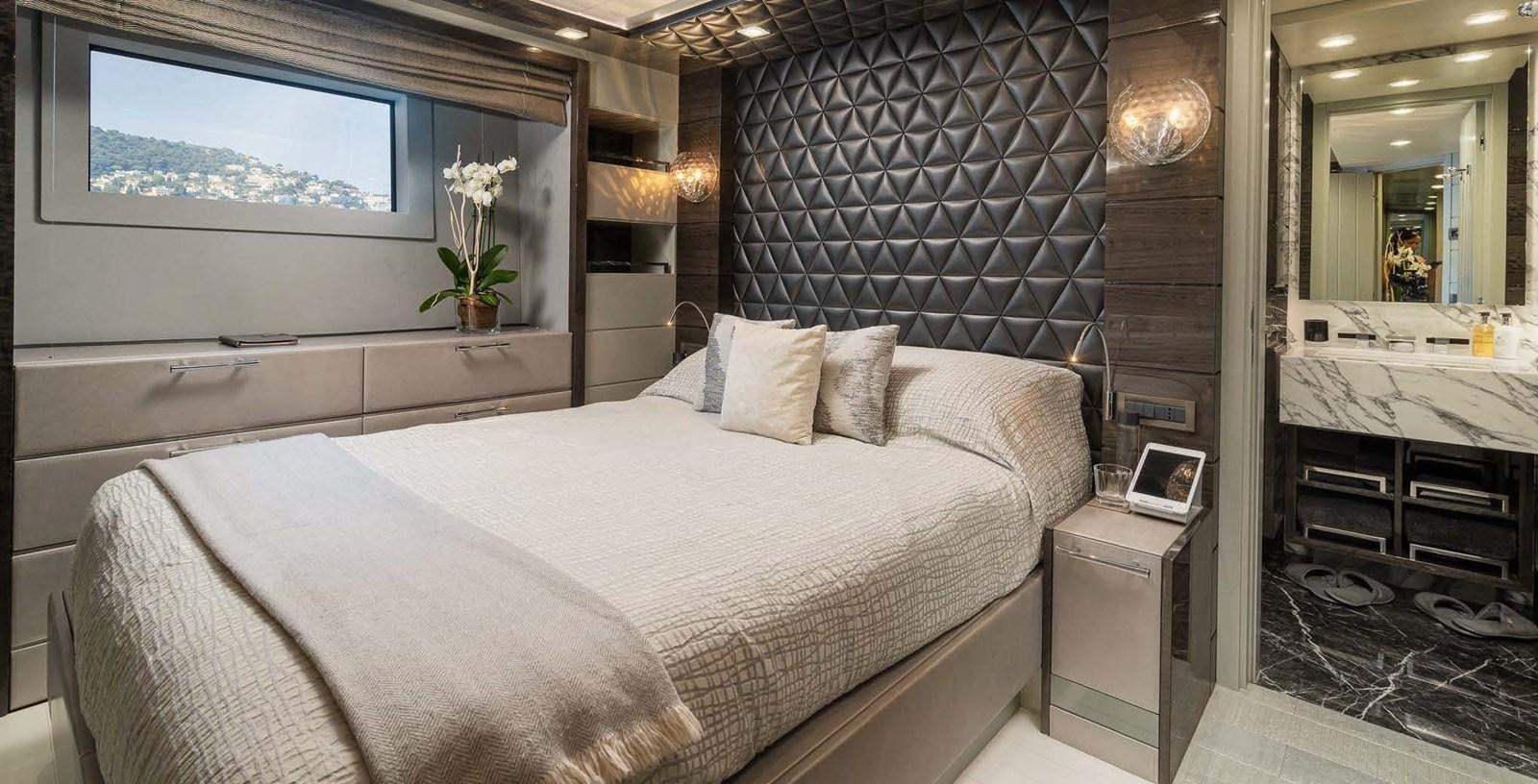 a room with a bed and a mirror aboard EDESIA Yacht for Charter