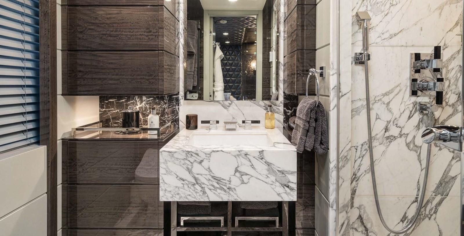 a bathroom with a sink and a mirror aboard EDESIA Yacht for Charter