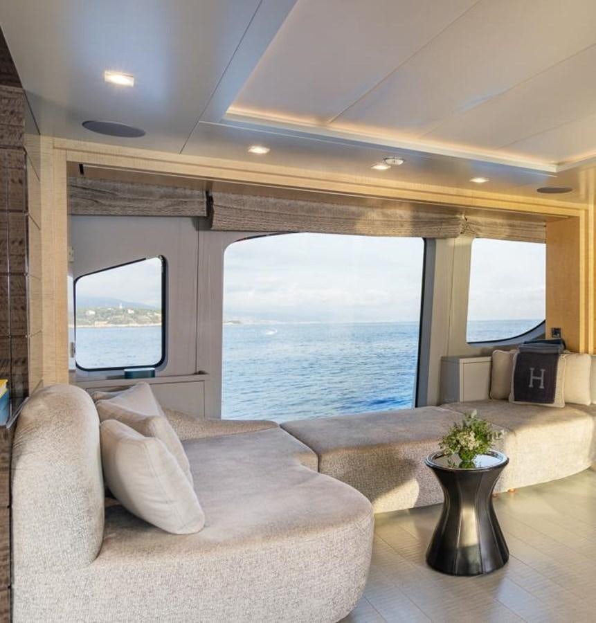 a living room with a large window aboard EDESIA Yacht for Charter