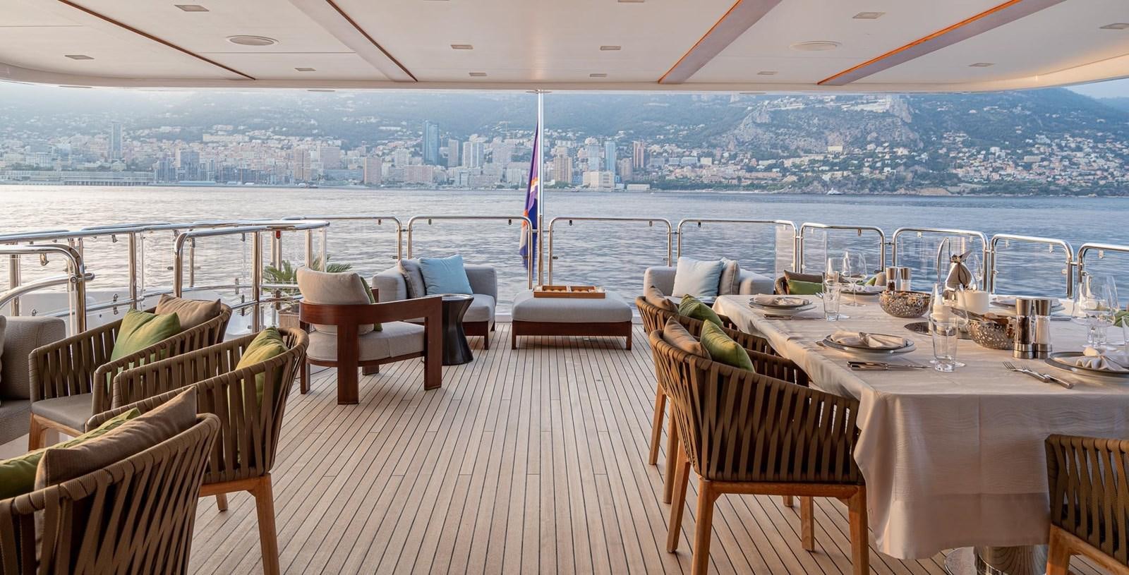 a room with tables and chairs aboard EDESIA Yacht for Charter