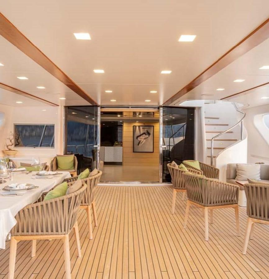 a large room with tables and chairs aboard EDESIA Yacht for Charter
