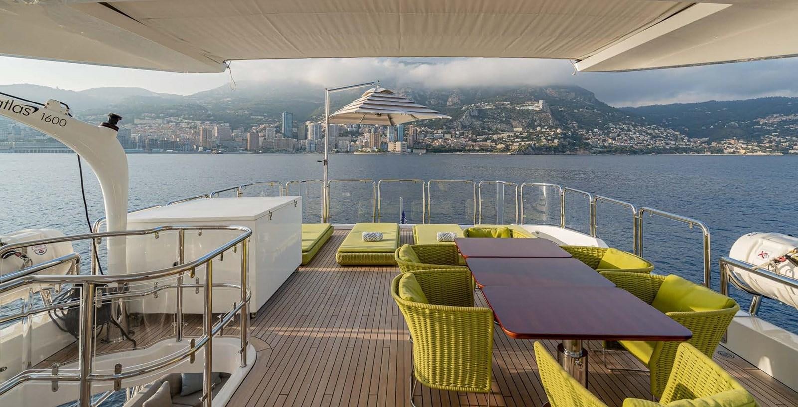 a deck with boats on it by a body of water aboard EDESIA Yacht for Charter