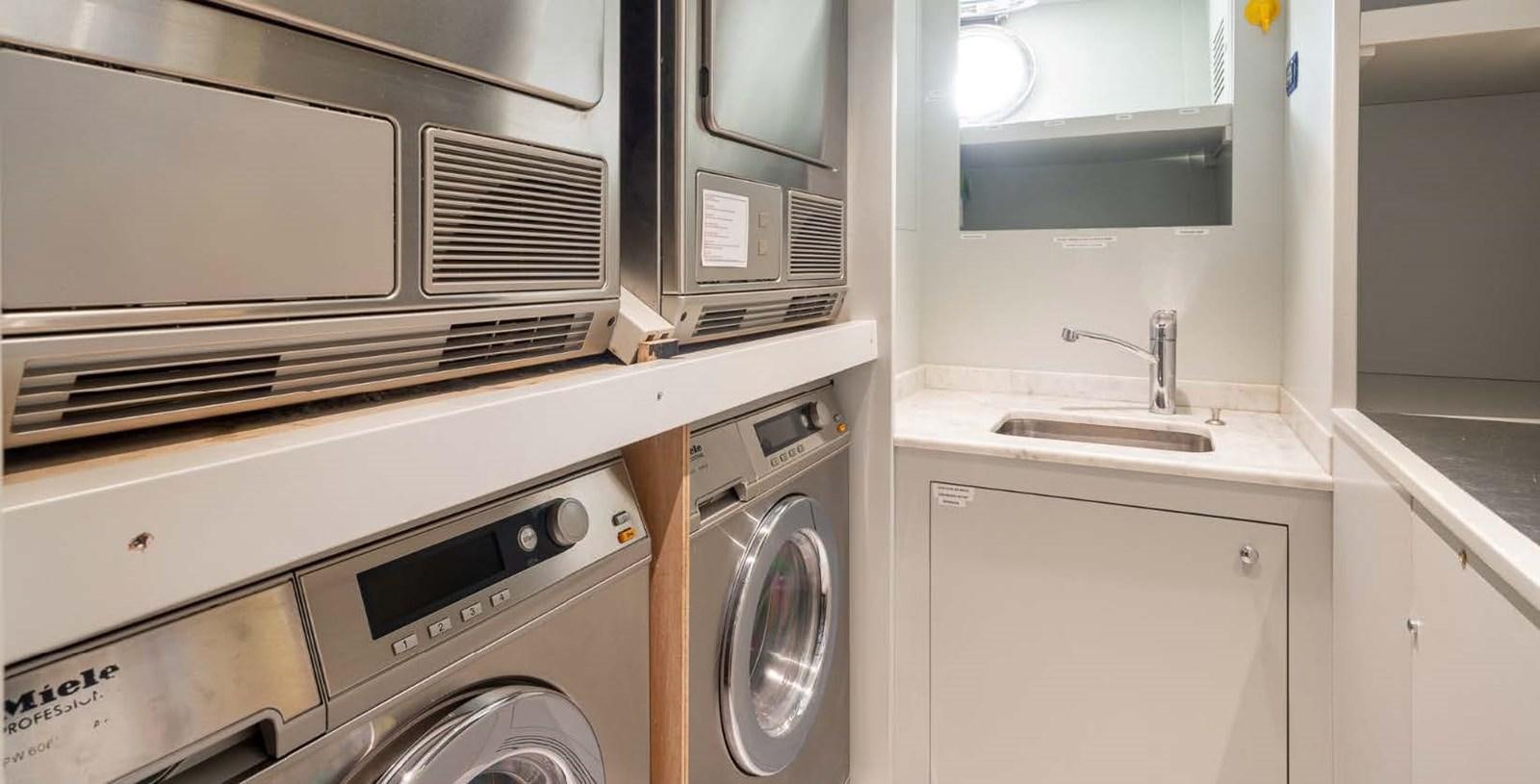 a kitchen with white cabinets aboard EDESIA Yacht for Charter