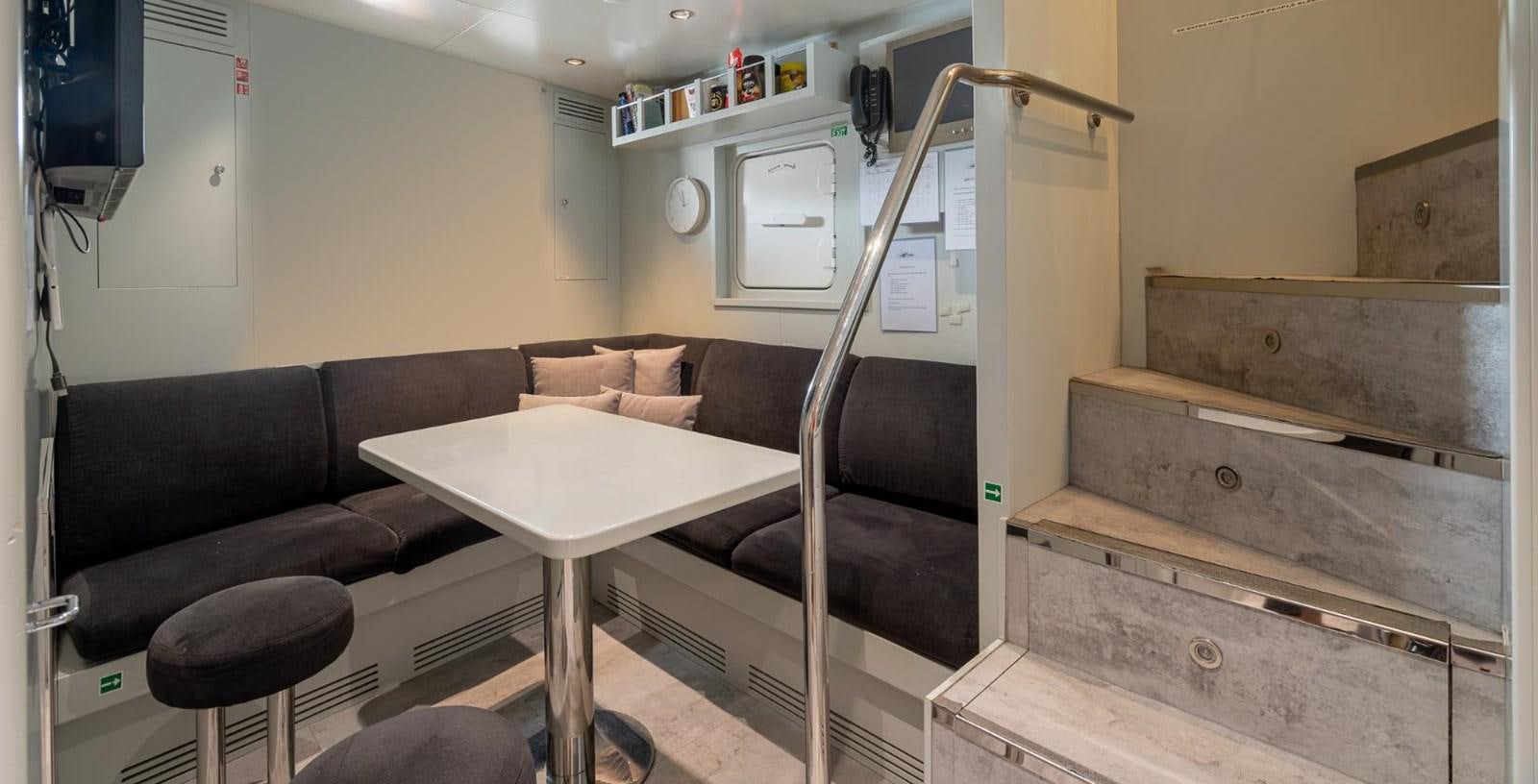 a bunk bed with a couch aboard EDESIA Yacht for Charter